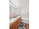 Bathroom with double sinks, tub, and wood vanity at 6404 Silver Mesa Dr # E, Highlands Ranch, CO 80130