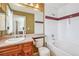 Bathroom featuring single sink, tub, and wallpaper at 6404 Silver Mesa Dr # E, Highlands Ranch, CO 80130