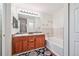 Bathroom featuring double sinks, tub, and wood vanity at 6404 Silver Mesa Dr # E, Highlands Ranch, CO 80130