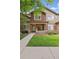 Charming brick townhouse with a covered front porch and well-maintained landscaping at 6404 Silver Mesa Dr # E, Highlands Ranch, CO 80130