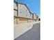 The exterior boasts townhome garages and matching siding under a clear blue sky at 6404 Silver Mesa Dr # E, Highlands Ranch, CO 80130