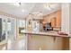 Modern kitchen with wood cabinets and a breakfast bar at 6404 Silver Mesa Dr # E, Highlands Ranch, CO 80130