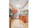 A kitchen featuring wood floors, cabinetry, and stainless appliances at 6404 Silver Mesa Dr # E, Highlands Ranch, CO 80130