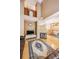 Bright and airy living room with hardwood floors, fireplace, and an open layout to the dining area at 6404 Silver Mesa Dr # E, Highlands Ranch, CO 80130