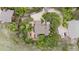 Aerial view of a property showcasing the house, driveway, landscaping, and surrounding trees at 5812 Irish Pat Murphy Dr, Parker, CO 80134