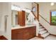 Well-lit bathroom with double vanity, wooden cabinets, and a view of the outside at 5812 Irish Pat Murphy Dr, Parker, CO 80134