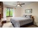 Comfortable bedroom with large window, ceiling fan, and built-in desk at 5812 Irish Pat Murphy Dr, Parker, CO 80134