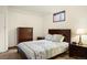 Cozy bedroom with a large bed, dresser and side tables with lamps at 5812 Irish Pat Murphy Dr, Parker, CO 80134
