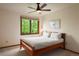 Cozy bedroom with a full-sized bed and lots of natural light coming in through the window at 5812 Irish Pat Murphy Dr, Parker, CO 80134