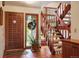 Welcoming foyer with wood door, tile floor, wood staircase, and stained glass window at 5812 Irish Pat Murphy Dr, Parker, CO 80134