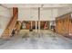 Spacious garage with a wide-open layout, storage shelving, and tools at 5812 Irish Pat Murphy Dr, Parker, CO 80134