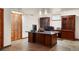 A spacious home office with wood cabinets and plenty of room for multiple workstations at 5812 Irish Pat Murphy Dr, Parker, CO 80134