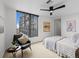 Bright bedroom with large windows offering city views, ceiling fan, and stylish decor at 1750 Wewatta St # 1501, Denver, CO 80202