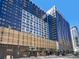 Stunning, modern apartment building boasting expansive windows and sleek architecture against a clear blue sky at 1750 Wewatta St # 1501, Denver, CO 80202