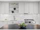Well-lit kitchen featuring modern cabinetry, stainless steel appliances, and a marble backsplash at 1750 Wewatta St # 1501, Denver, CO 80202