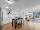 Modern kitchen featuring white cabinetry, stainless steel appliances, hardwood floors, and an island with seating at 1750 Wewatta St # 1501, Denver, CO 80202