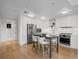 Contemporary kitchen with stainless steel appliances, white cabinetry, and hardwood floors, perfect for cooking at 1750 Wewatta St # 1501, Denver, CO 80202