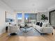 Bright living room featuring stylish seating, city views, modern lighting, and chic decor on hardwood floors at 1750 Wewatta St # 1501, Denver, CO 80202