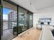 Light-filled living room with balcony featuring large windows with city views at 1750 Wewatta St # 1501, Denver, CO 80202
