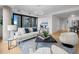 Modern living room with large windows offering city views, comfortable seating, and stylish decor at 1750 Wewatta St # 1501, Denver, CO 80202
