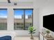 Bright main bedroom featuring stylish decor, city views, and a modern ceiling fan at 1750 Wewatta St # 1501, Denver, CO 80202