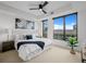 Bright main bedroom featuring stylish decor, city views, and a modern ceiling fan at 1750 Wewatta St # 1501, Denver, CO 80202