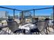 Chic rooftop seating area featuring comfortable wicker chairs and a modern fire pit, perfect for city views at 1750 Wewatta St # 1501, Denver, CO 80202