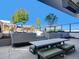Inviting rooftop deck features a concrete block bench, and a dining table for entertaining at 1750 Wewatta St # 1501, Denver, CO 80202