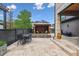 Inviting backyard featuring a charming pergola, an outdoor dining set, and a well-maintained stone patio at 8565 E 50Th Dr, Denver, CO 80238