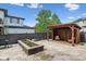 Charming backyard with a cozy pergola and stylish patio featuring a well-manicured garden and outdoor seating at 8565 E 50Th Dr, Denver, CO 80238