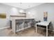 Stylish bar area features modern seating, a countertop with a sink, and decorative pendant lights at 8565 E 50Th Dr, Denver, CO 80238