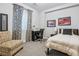 Cozy bedroom boasts carpet floors, a sleek black desk, a comfortable chair, and car-themed decorations at 8565 E 50Th Dr, Denver, CO 80238