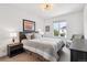 Comfortable bedroom features a large window with a seating area and contemporary decor at 8565 E 50Th Dr, Denver, CO 80238