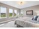 Serene bedroom with large windows, soft lighting, and comfortable furnishings at 8565 E 50Th Dr, Denver, CO 80238