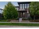 Contemporary home with a well-kept lawn, professional landscaping, and a striking gray brick design at 8565 E 50Th Dr, Denver, CO 80238