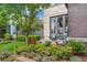 Inviting outdoor patio area with green lawn, thriving shrubbery, and cozy seating for relaxation at 8565 E 50Th Dr, Denver, CO 80238