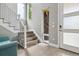 Bright foyer with modern staircase, hardwood floors, and a welcoming entry area, filled with natural light at 8565 E 50Th Dr, Denver, CO 80238
