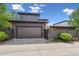Contemporary garage with a spacious driveway and well-maintained landscaping, adding curb appeal at 8565 E 50Th Dr, Denver, CO 80238