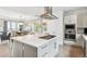Contemporary kitchen with a spacious island, stainless steel appliances, and an open layout to the dining area at 8565 E 50Th Dr, Denver, CO 80238
