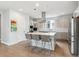 Modern kitchen boasting a large center island, stainless steel appliances, and sleek gray cabinetry at 8565 E 50Th Dr, Denver, CO 80238