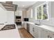 Modern kitchen boasts white cabinets, stainless steel appliances, and a light countertop with window views at 8565 E 50Th Dr, Denver, CO 80238