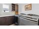 Well-equipped laundry room with modern washer and dryer units and storage space at 8565 E 50Th Dr, Denver, CO 80238