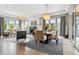Open-concept living area with fireplace, modern lighting fixtures, and expansive windows at 8565 E 50Th Dr, Denver, CO 80238