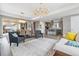 Open concept living room with kitchen and dining areas at 8565 E 50Th Dr, Denver, CO 80238