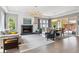 Open-concept living room with fireplace and lots of natural light at 8565 E 50Th Dr, Denver, CO 80238