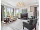 Bright living room with hardwood floors, fireplace, and large windows at 8565 E 50Th Dr, Denver, CO 80238