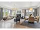 Bright living room featuring a fireplace, hardwood floors, and dining area at 8565 E 50Th Dr, Denver, CO 80238