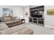 Cozy living room features comfortable seating and a large entertainment center at 8565 E 50Th Dr, Denver, CO 80238