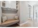 Functional mudroom with built-in bench, storage cabinets, and hooks for organization at 8565 E 50Th Dr, Denver, CO 80238