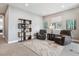 Cozy sitting room with comfortable chairs, stylish shelving, and neutral decor at 8565 E 50Th Dr, Denver, CO 80238